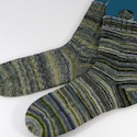 Pair of socks made from differently-plied yarn